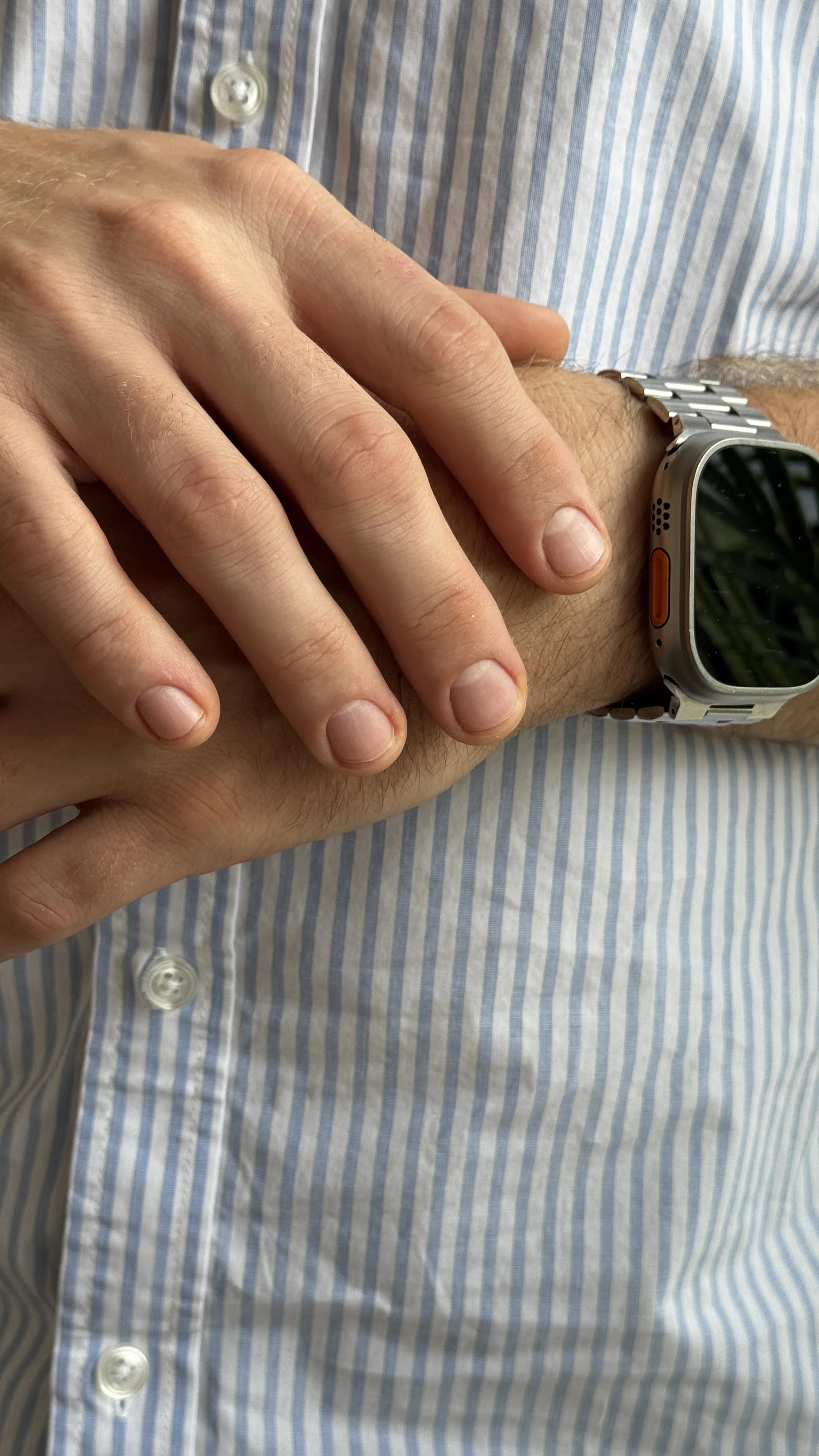 Buffed natural men's nails with groomed cuticles and an Apple Watch, a clean men's manicure at My Beauty Space Mississauga.
