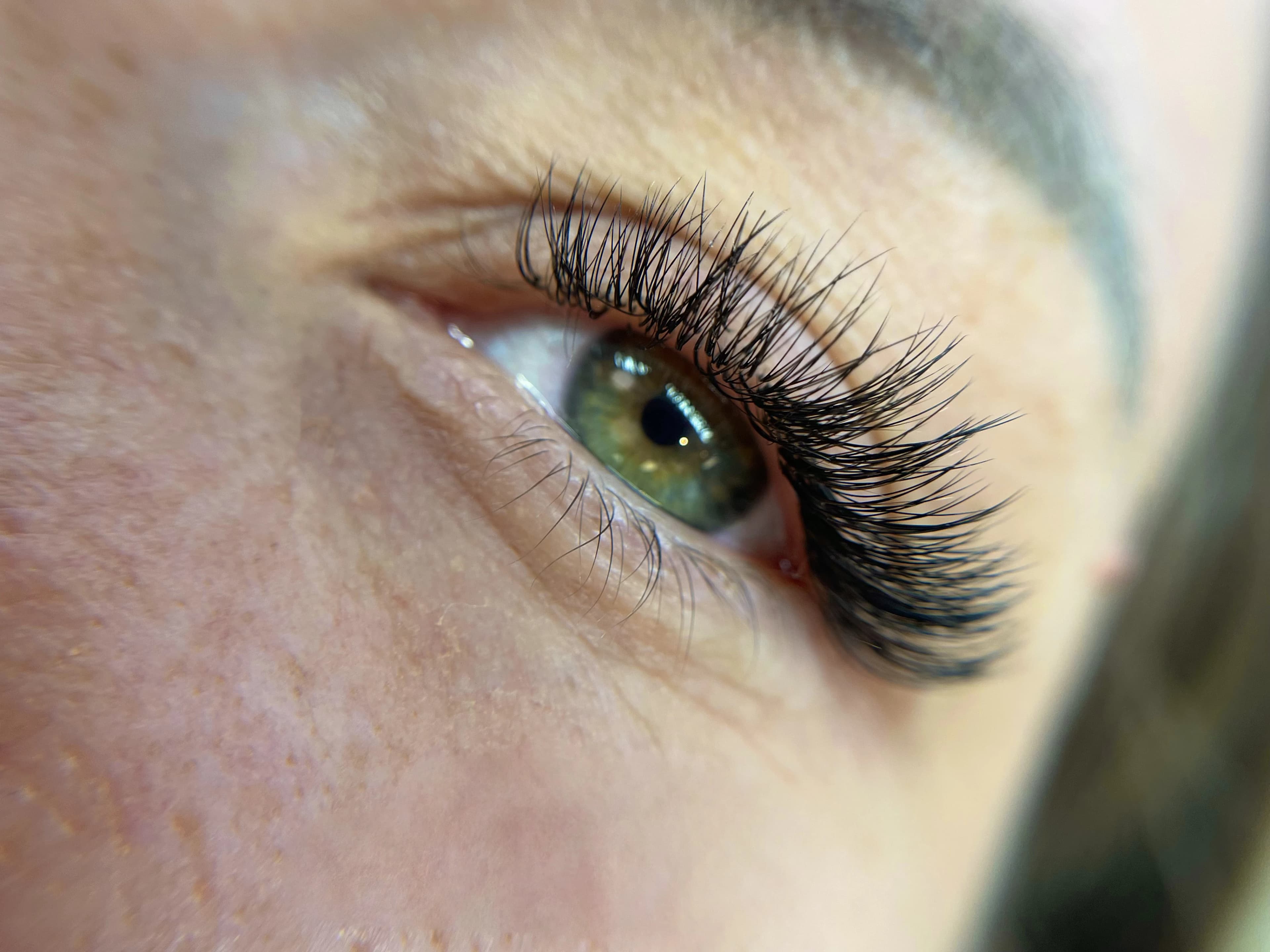 Freckled skin and green eyes with light hybrid 2D lashes flared at the outer corner at My Beauty Space.