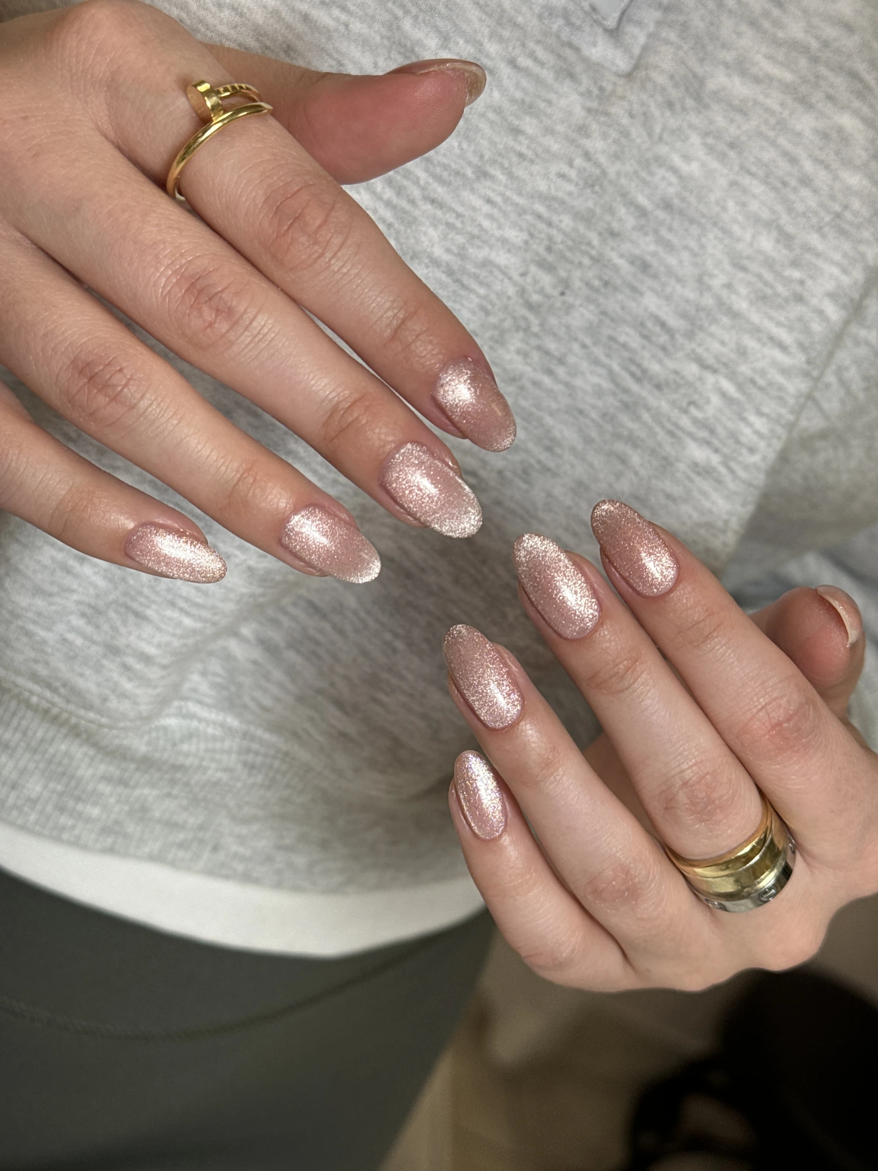 Rose-gold cat-eye nail design at My Beauty Space on medium almond nails with a velvety magnetic shimmer finish.