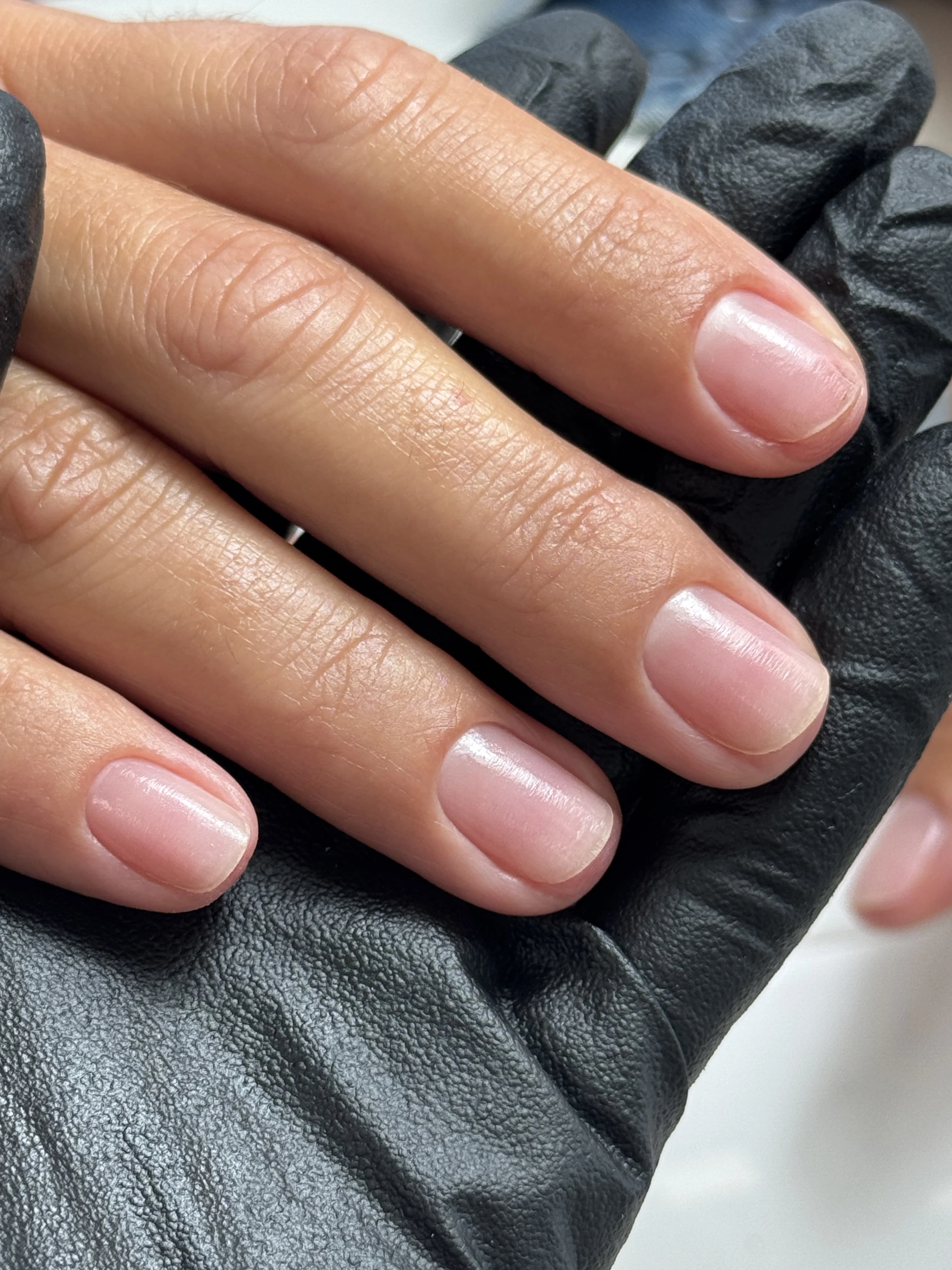 Buffed natural nails with a clear high-shine finish on short rounded tips after a no-polish manicure at My Beauty Space Mississauga.