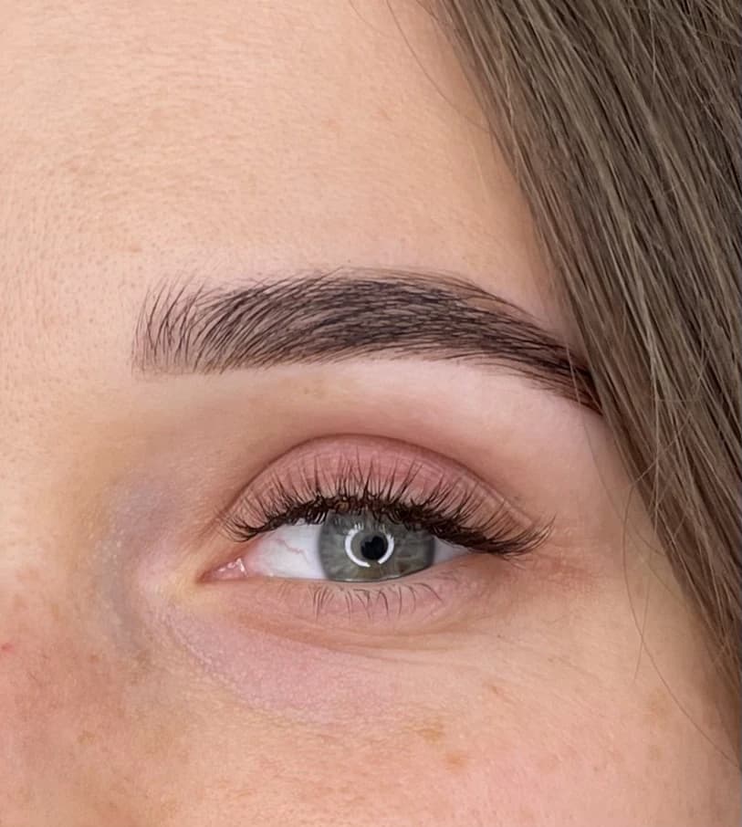 Classic lash extensions with outer-corner length and a groomed brow arch on blue-grey eyes at My Beauty Space Mississauga.