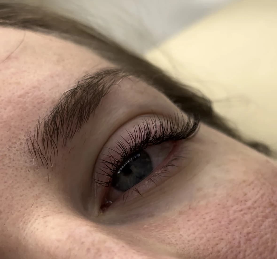 Blue-grey eye with full classic lash extensions tapered longer at the outer corner at My Beauty Space Mississauga.