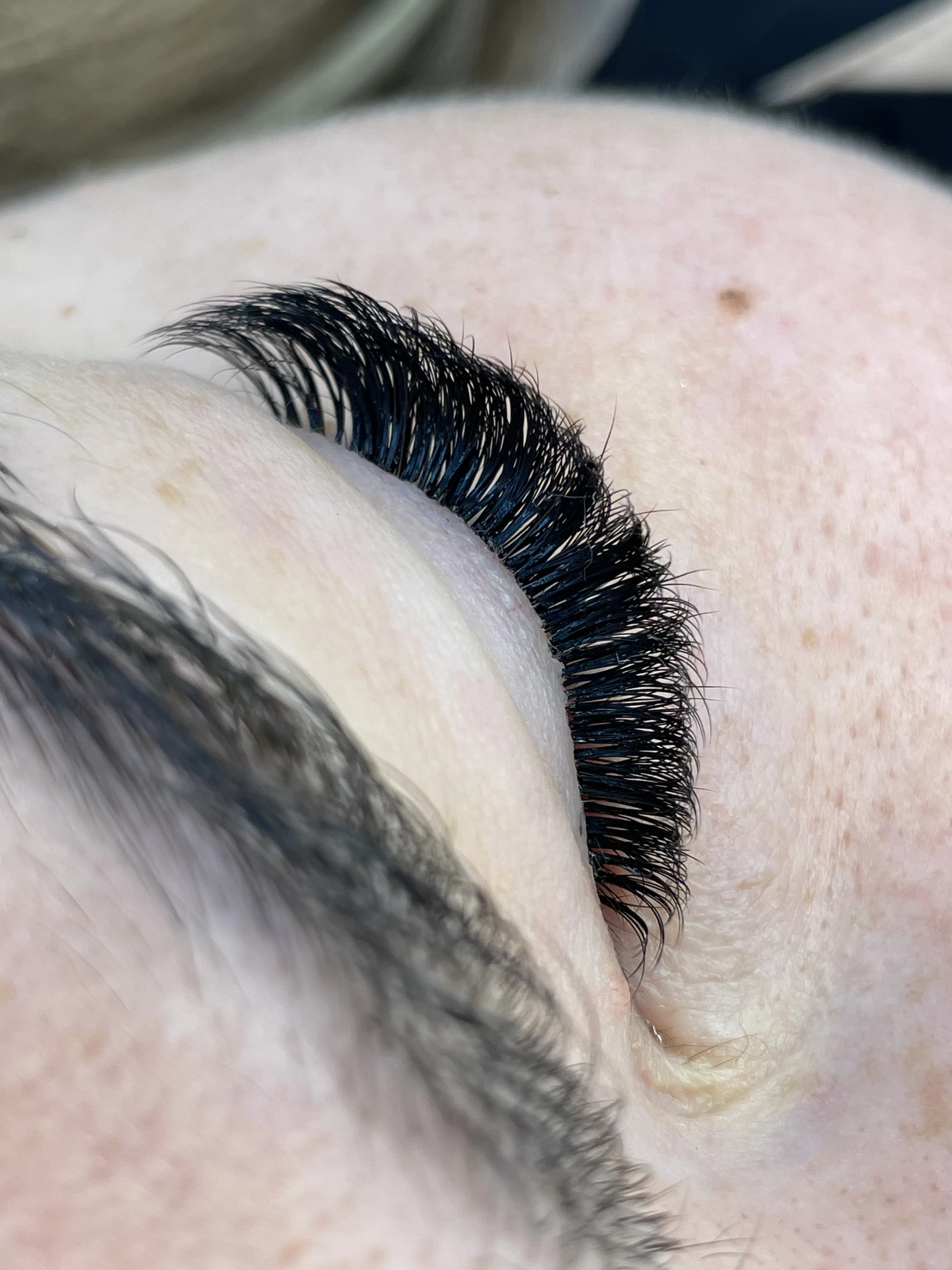 Closed-eye 4D volume lash extensions with fluffy jet-black fans and soft freckles at My Beauty Space Mississauga.