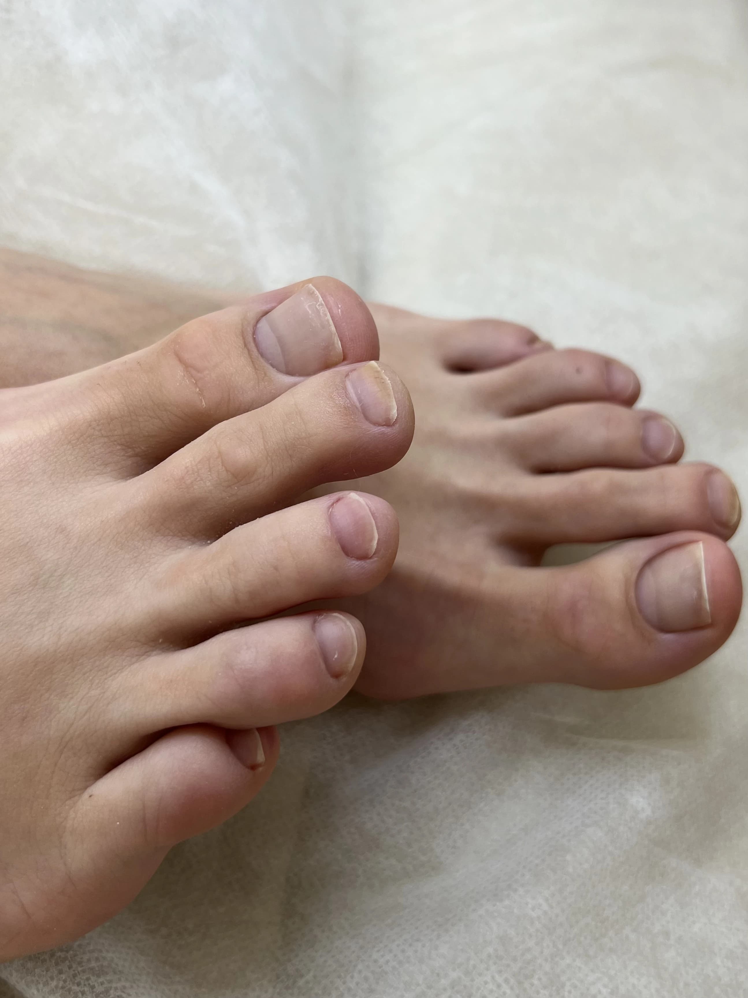 Natural no-polish pedicure at My Beauty Space Mississauga: short buffed toenails with clean cuticles on white paper.