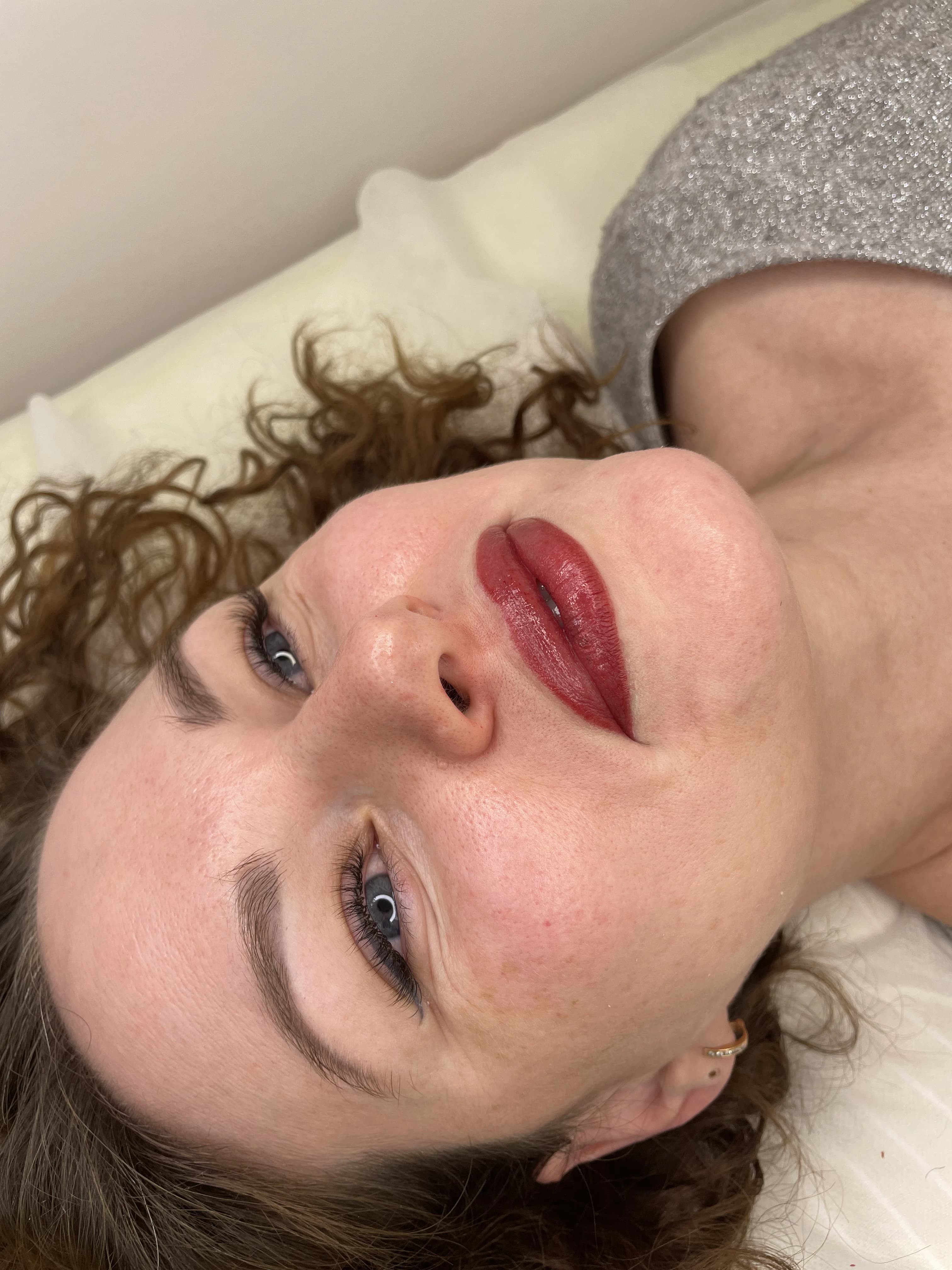 Permanent lip blush in deep berry-red with shaped brows and volume lashes at My Beauty Space Mississauga.