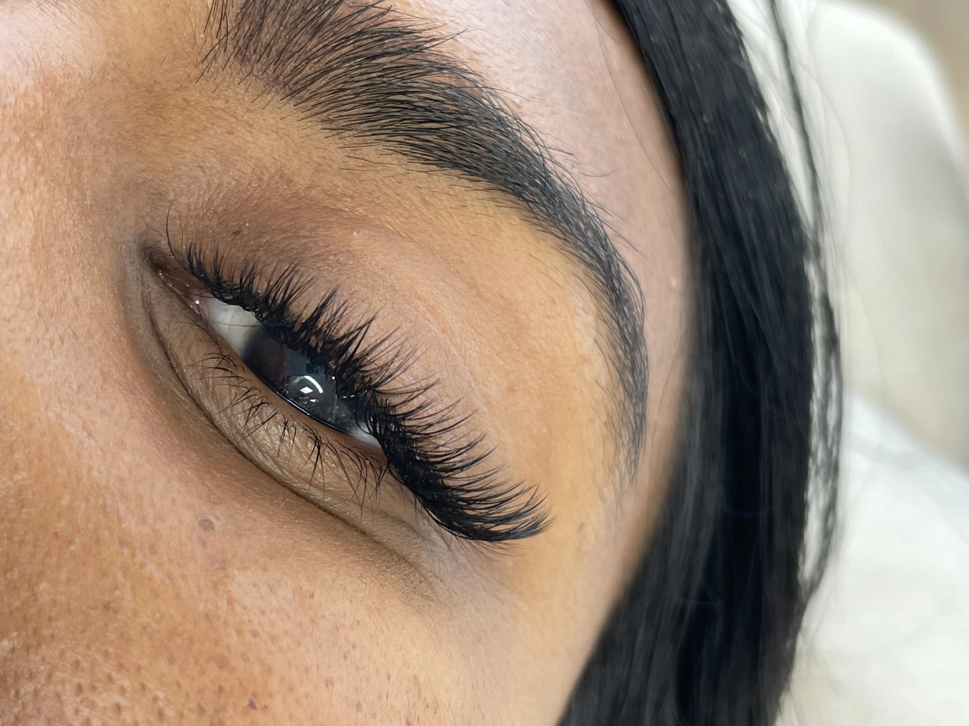 Medium-tan skin with light hybrid 2D lash fans and a sharp arched brow at My Beauty Space Mississauga.