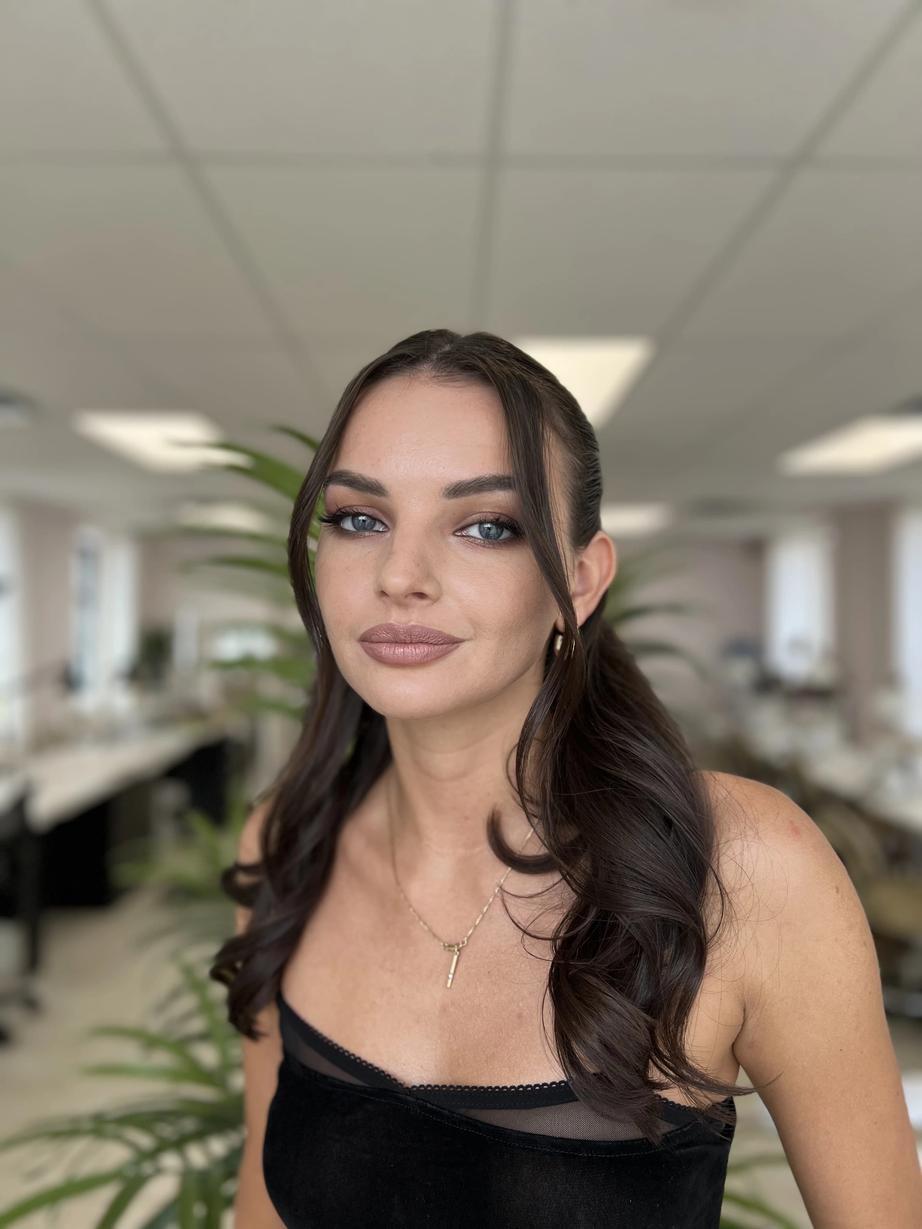 Smokey eye makeup with half-up curled waves and mauve lips, styled at My Beauty Space Mississauga.